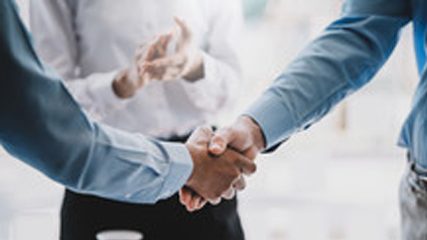 Partners shaking hands on an energy agreement